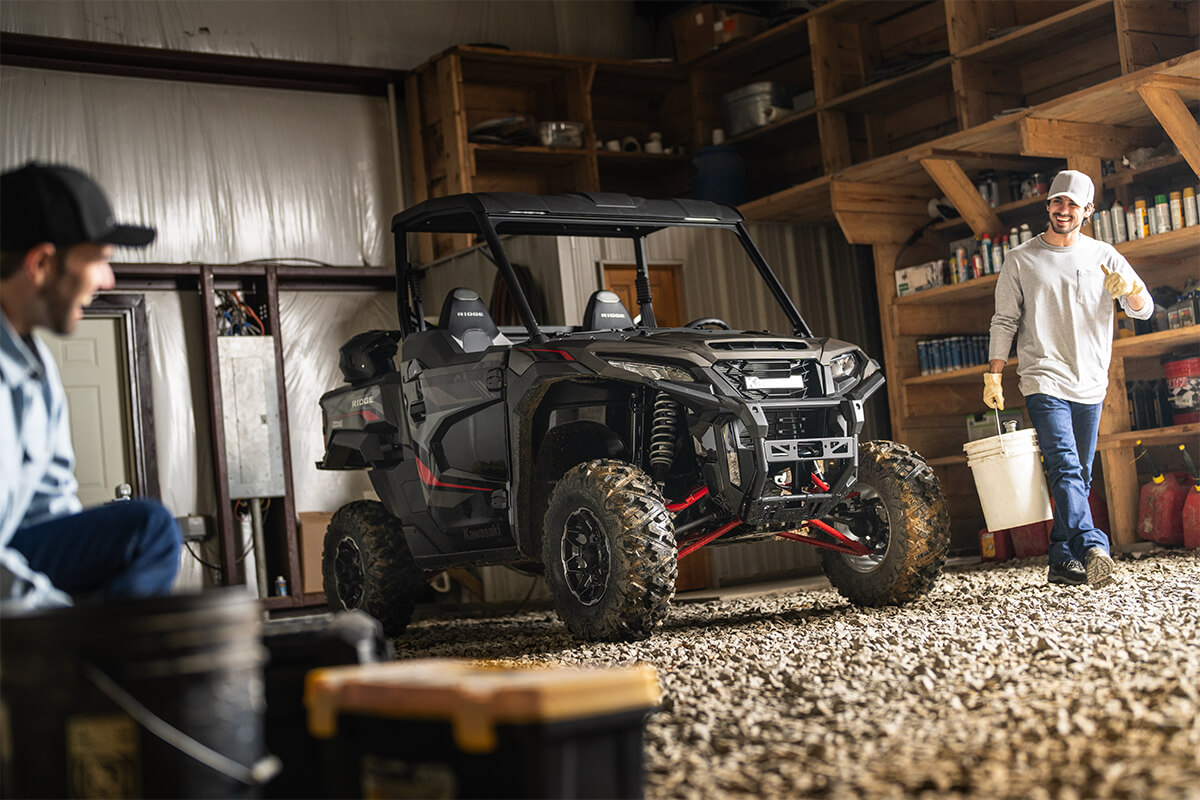 Three-quarter front angle of a side x side parked in a garage.