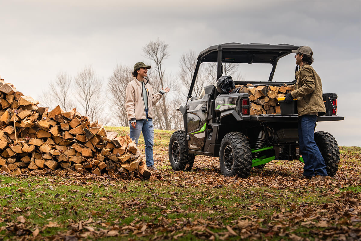 Three-quarter rear angle of a parked side x side being loaded.
