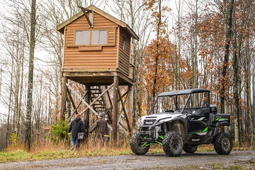 Three-quarter front angle of a side x side parked near an outpost. opens in a new window
