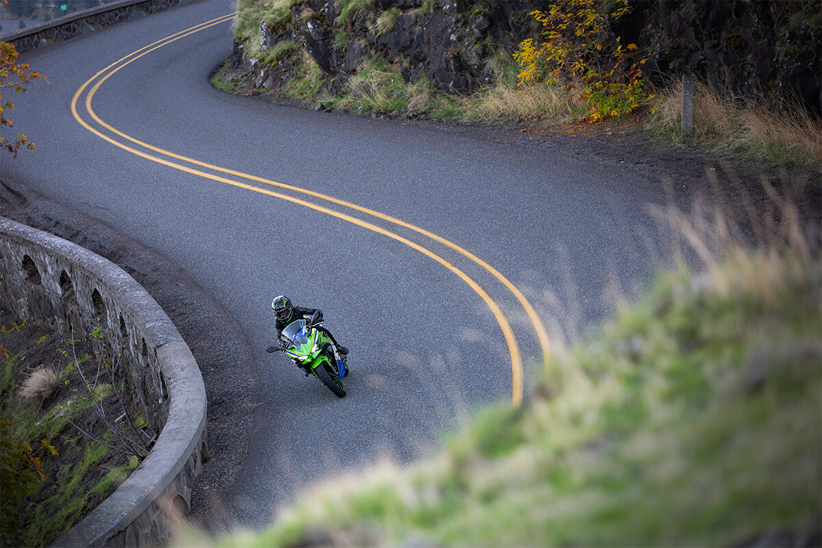 Front angle of a person riding a motorcycle on a road.