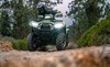 Front angle of a person riding an ATV on a trail.
