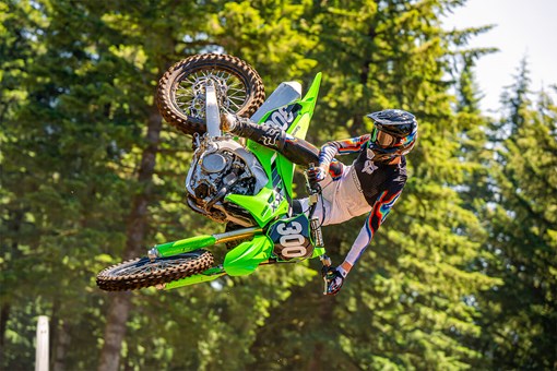 Side angle of a person whipping a motorcycle in midair. opens in a new window