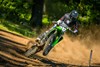 Front angle of a person riding a motorcycle on a track.