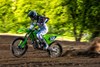 Profile angle of a person riding a motorcycle on a track.