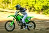 Side angle of a person riding a motorcycle on a track.