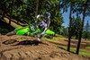 Three-quarter front angle of a person riding a motorcycle on a track.