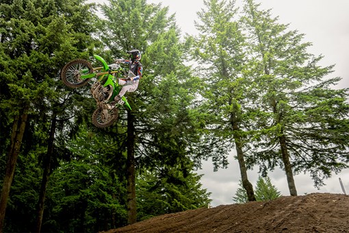 Three-quarter front angle of a person riding a motorcycle in midair. opens in a new window