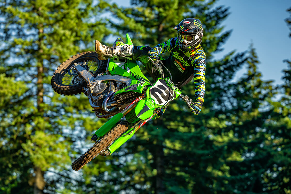 Three-quarter front angle of a person on a motorcycle in midair.