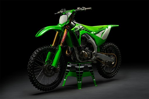 Three-quarter front angle of a green motorcycle staged in a black studio background. opens in a new window