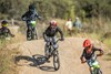 Front angle of multiple young adults riding electric balance bikes. 