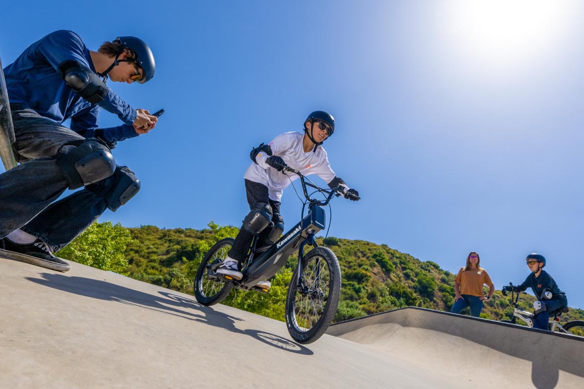 Ground level angle of a young adult riding an electric balance bike.