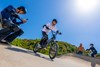 Ground level angle of a young adult riding an electric balance bike.