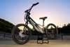 Three-quarter front angle of an electric balance bike parked outside.