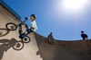 Upward side angle of a young adult riding an electric balance bike around a large turn.