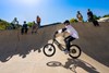 Upward side angle of a young adult riding an electric balance bike.