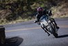 Front angle of a person riding a motorcycle on a highway.