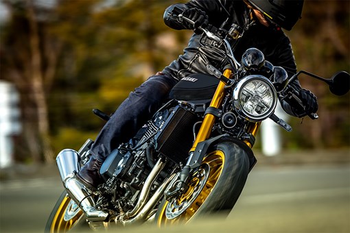 Three-quarter front angle of a person riding a motorcycle and making a turn. opens in a new window