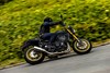 Side angle of a person riding a motorcycle on a highway.