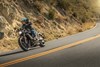 Side angle of a person riding a motorcycle on a highway.