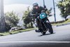 Front angle of a person riding a motorcycle on a highway.