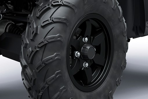 Close-up view of a wheel and off-road tire of an ATV. opens in a new window
