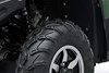 Detail view of the tire tread and alloy wheel of an ATV.