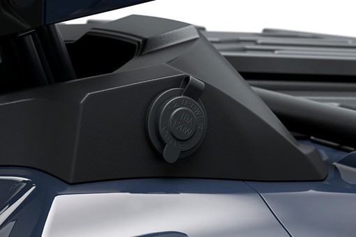Close-up view of a 12V power outlet on an ATV. opens in a new window