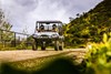 Three-quarter front angle of a person driving a side x side off-road.