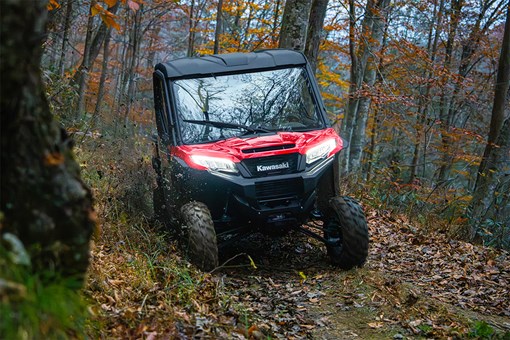Front view of a person driving a side x side off-road. opens in a new window
