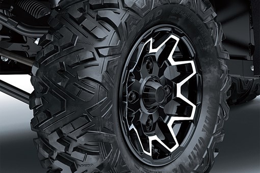 Detail view of the front right wheel and tire of a side x side. opens in a new window