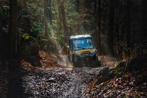 Front view of a person driving a side x side off-road. opens in a new window