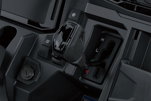 Close-up view of the gear shifter of a side x side. opens in a new window