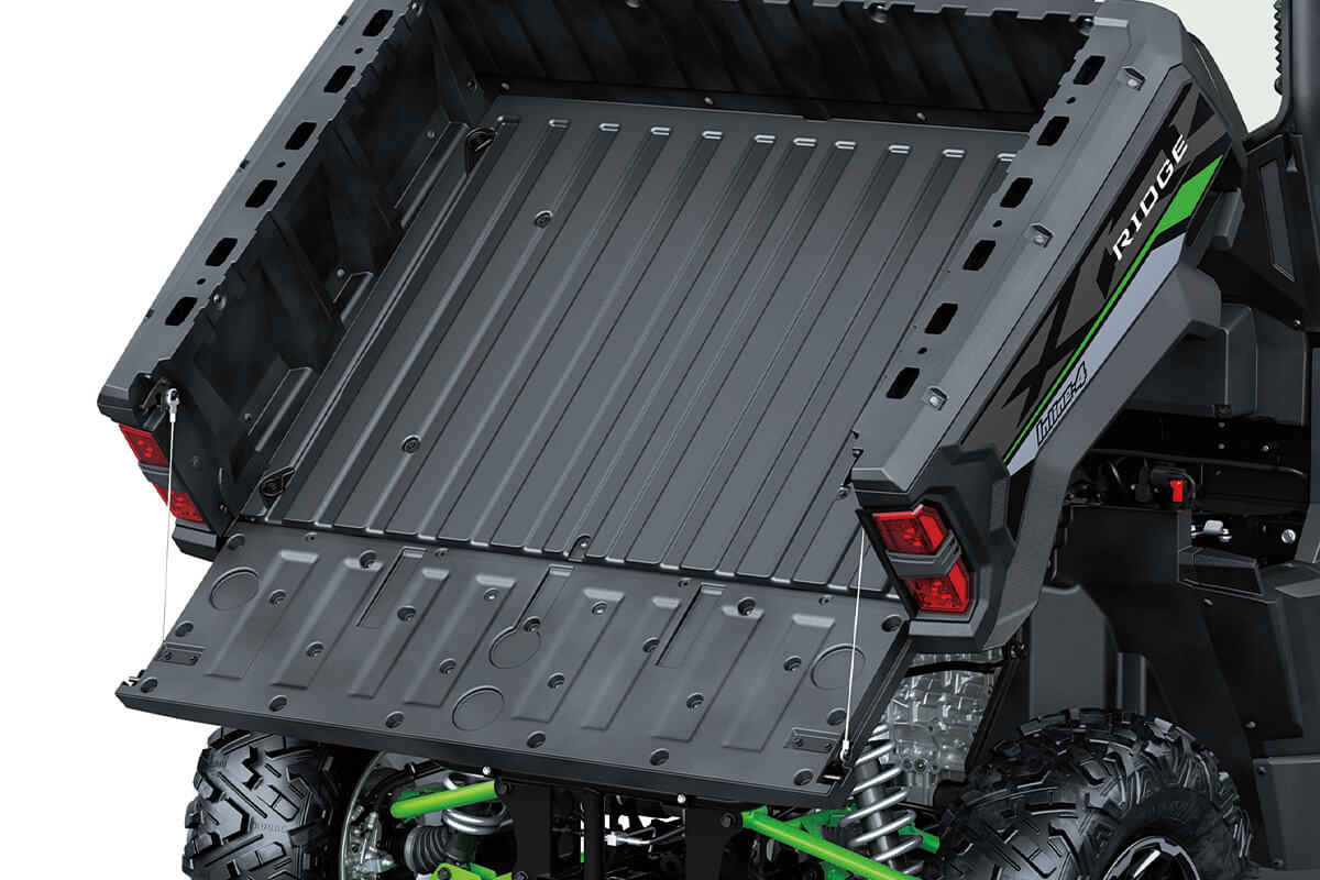 Front angle of the raised cargo bed of a side x side staged in a white studio background.