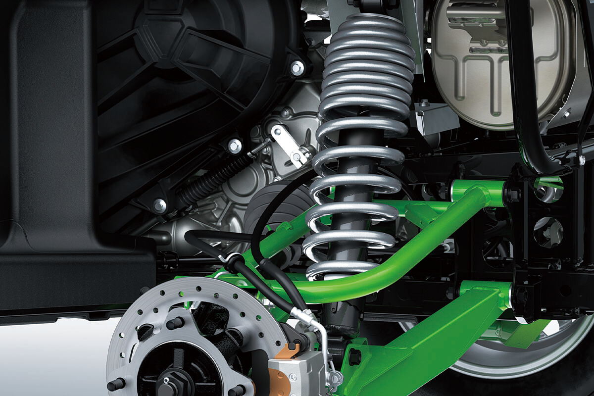 Close-up view of the shock and A-arm of a side x side staged in a white studio background.