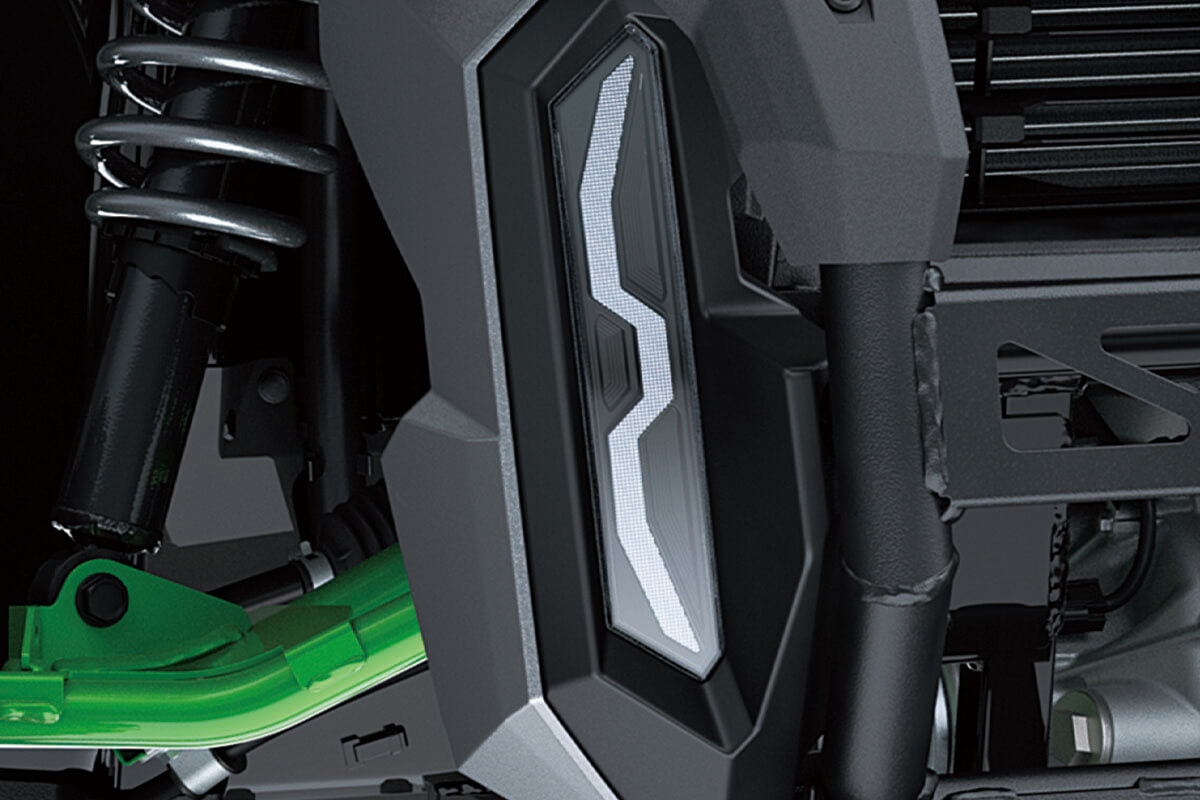 Close-up view of the headlight of a side x side.