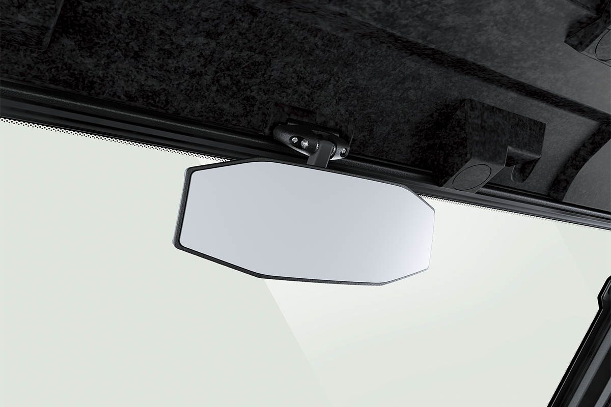 Close-up view of the rearview mirror of a side x side staged in a white studio background.