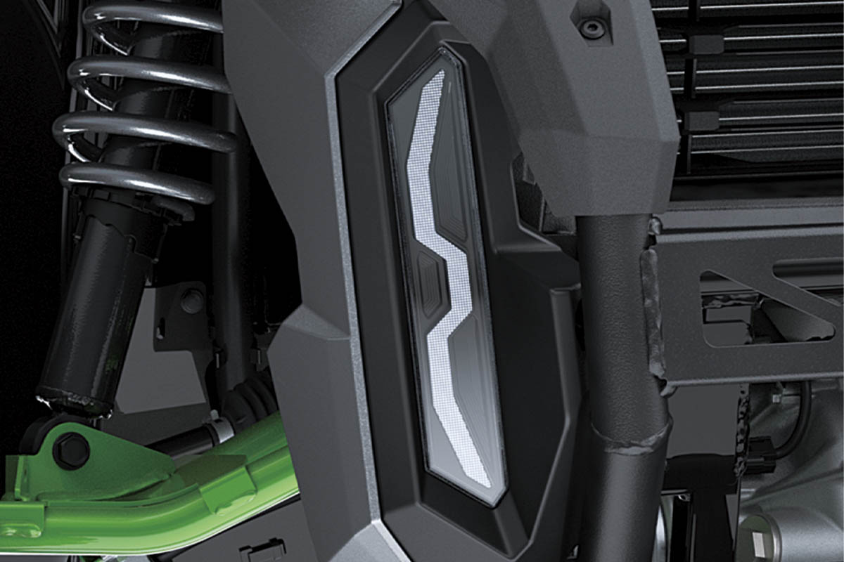 Close-up view of the headlight of a side x side.