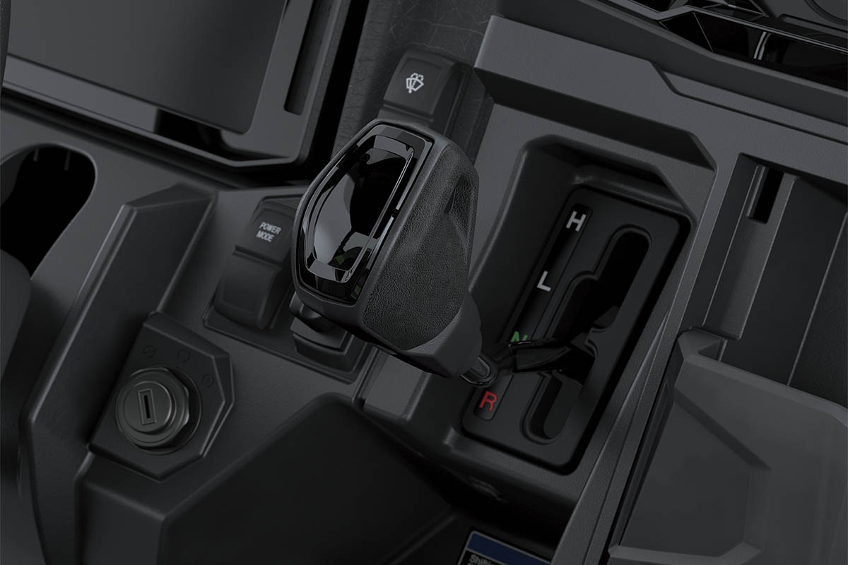 Close-up view of the gear shifter of a side x side.