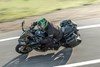 Above angle of a person riding a motorcycle on a highway.