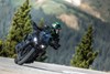 Front angle of a person riding a motorcycle on a highway.