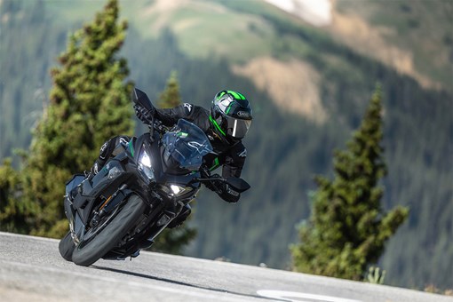 Front angle of a person riding a motorcycle on a highway. opens in a new window