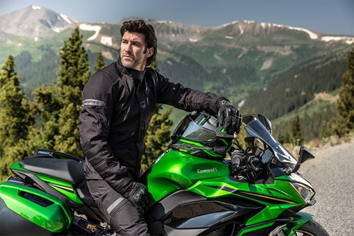 Profile angle of a person seated on a motorcycle. opens in a new window