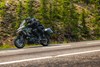 Side angle of a person riding a motorcycle on a highway.