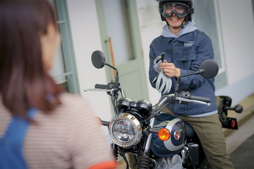 Front angle of a person seated on a motorcycle. opens in a new window