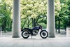 Side angle of a motorcycle parked in a colonnade.