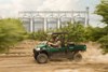 Side angle of a person driving a side x side off-road.