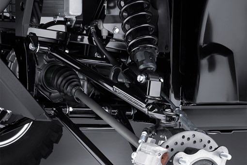 Detailed angle view of the A-arm, shock and brake rotor of a side x side. opens in a new window