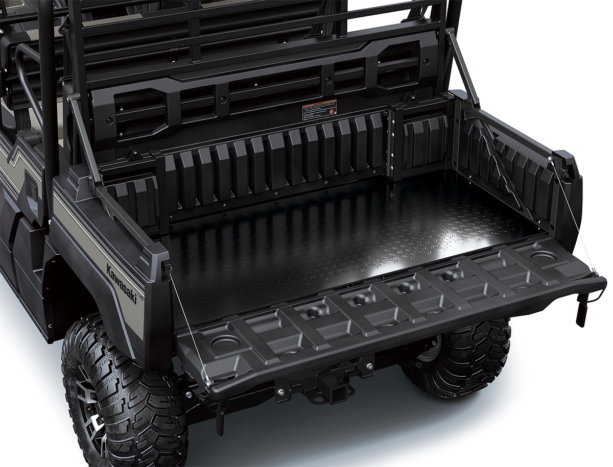 Top-down view of cargo bed of a side x side with the tailgate down.