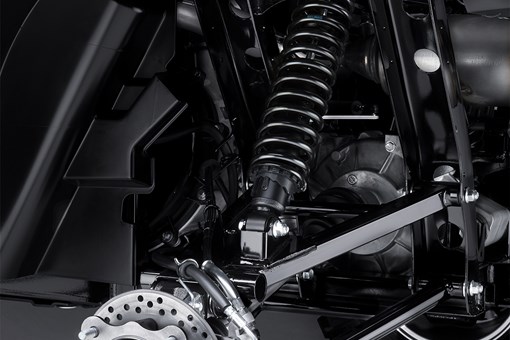 Angle view of the A-arm, shock and brake rotor of a side x side. opens in a new window