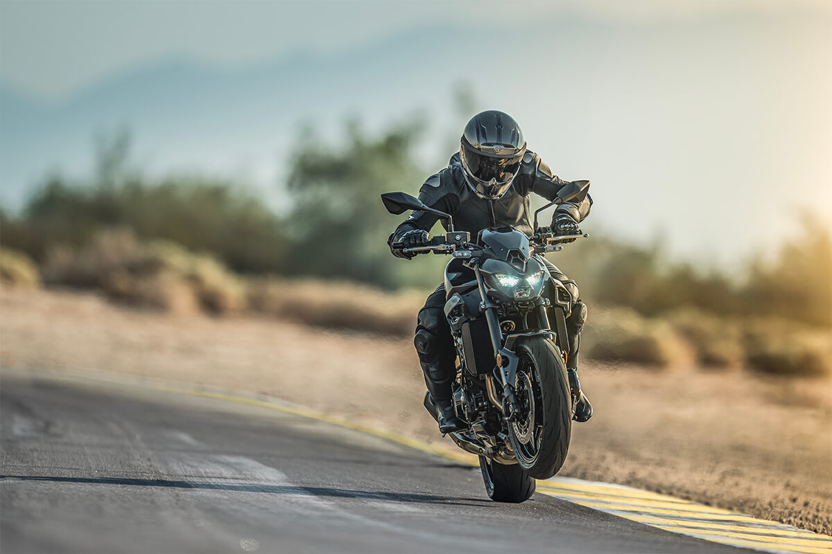 Front angle of a person riding a motorcycle on a track.